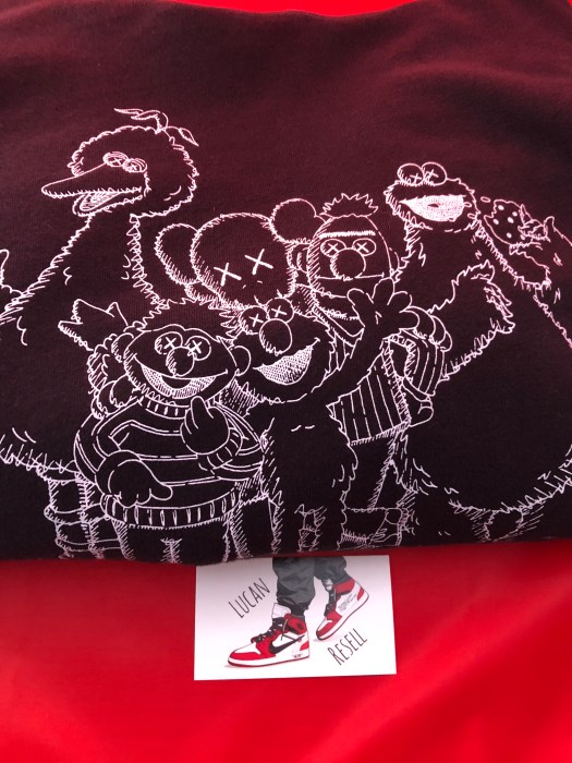 black kaws hoodie collab with uniqlo and sesame st